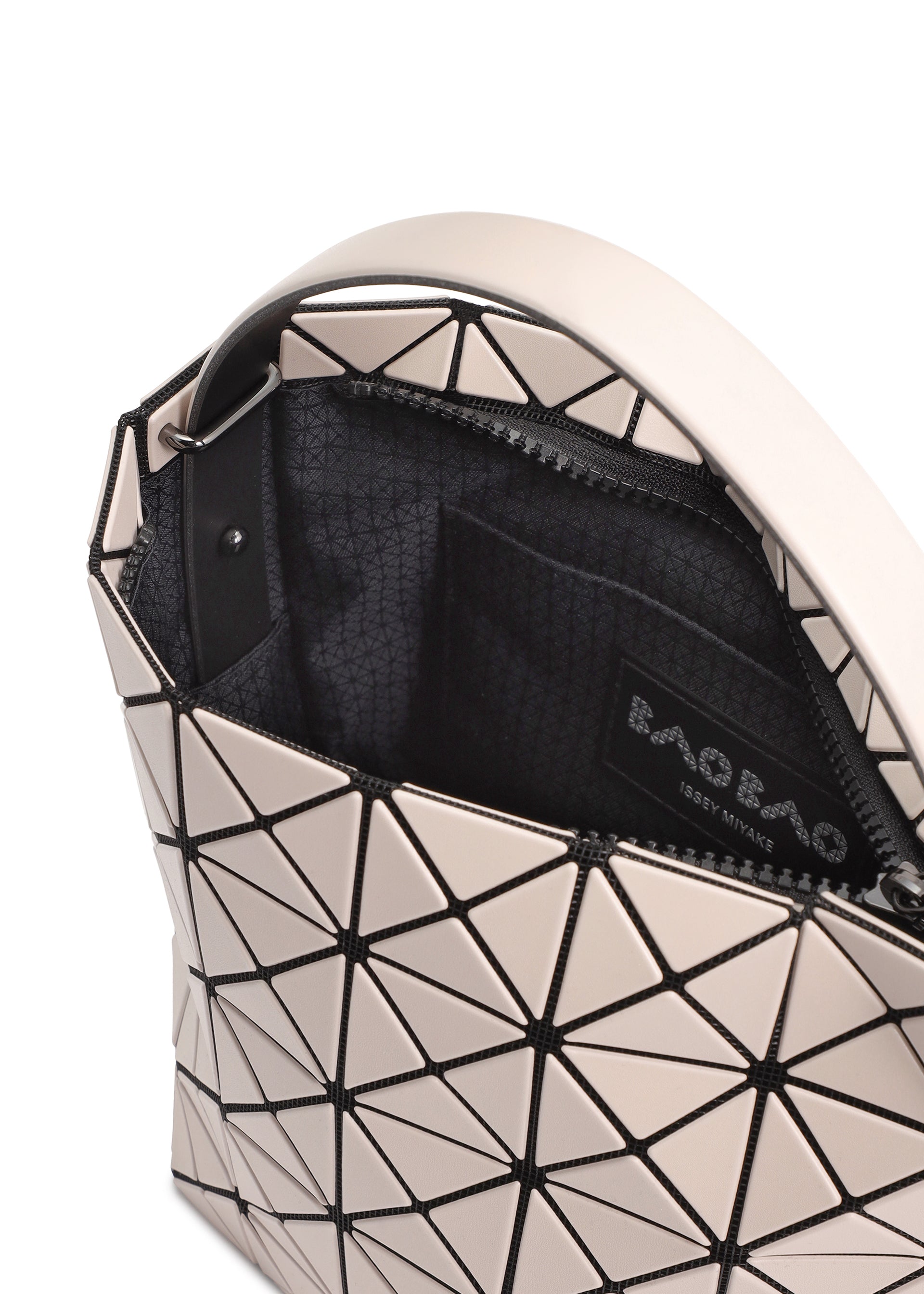 Zoomed view A close-up of the VALLEY handbag by BAO BAO ISSEY MIYAKE, featuring a geometric triangular pattern, partially open zipper, glimpse of its black interior with brand label, and a gusseted design for upright standing.