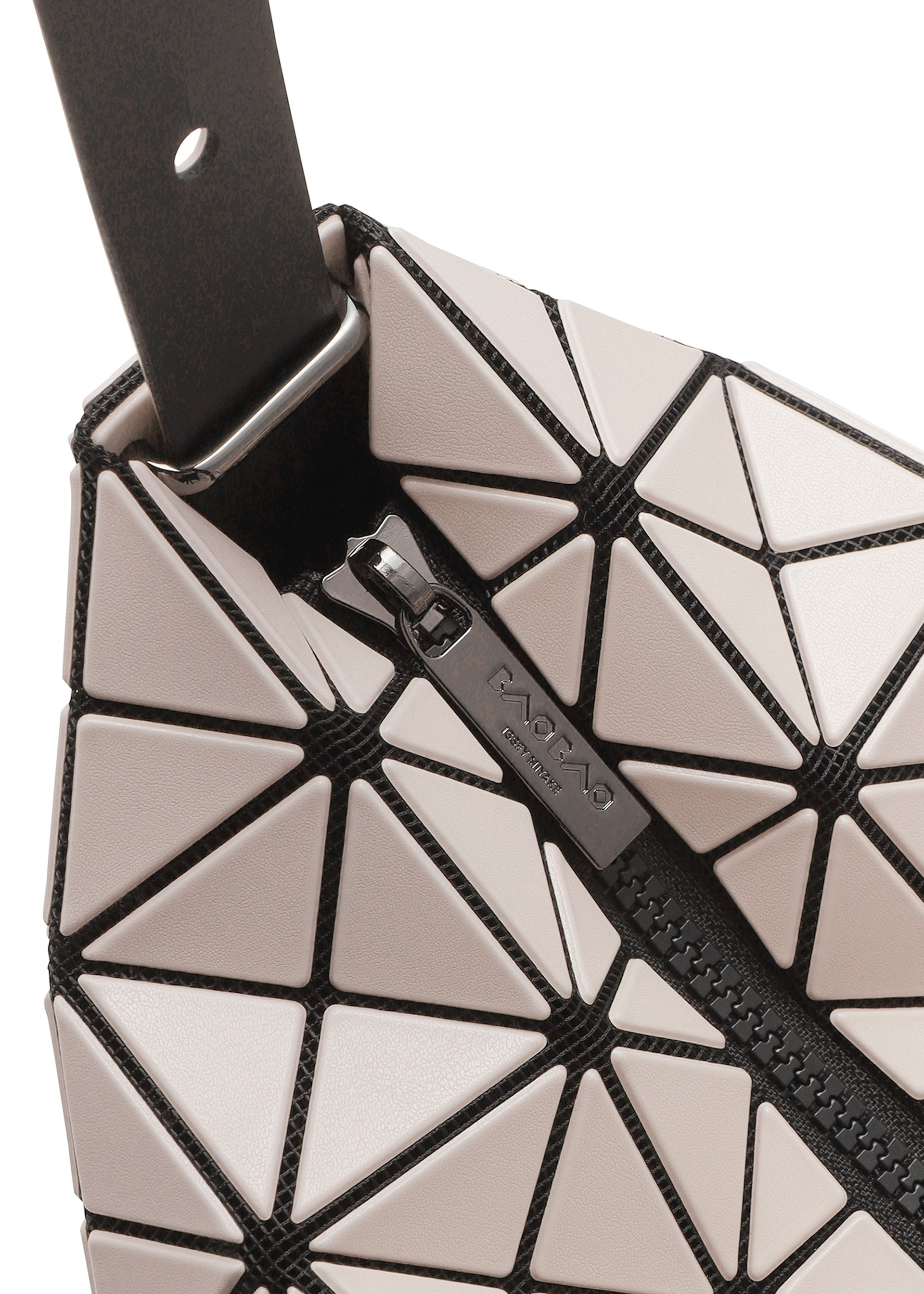 Zoomed view Close-up of VALLEY by BAO BAO ISSEY MIYAKE, a geometric gusseted handbag with glossy light triangles outlined in black, triangular panels, visible zipper, and a black strap attached by a metal loop at the corner.