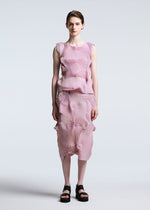 A person with short hair stands against a light background, wearing the sleeveless pink and white striped Steam Stretch set with textured wavy details, paired with TYPE-O 003 BK black platform sandals by A-POC ABLE ISSEY MIYAKE.