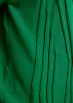 Close-up of green TYPE-K 003-1 fabric by A-POC ABLE ISSEY MIYAKE, showing vertical slits with frayed edges and soft, textured surface—a result of Steam Stretch’s unique three-dimensional knitting technique.
