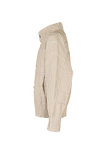 The TYPE-O 002 jacket by A-POC ABLE ISSEY MIYAKE features a beige grid pattern, high collar, ribbed cuffs and hem, and lightweight stretch fabric. Shown in side profile against a white background.