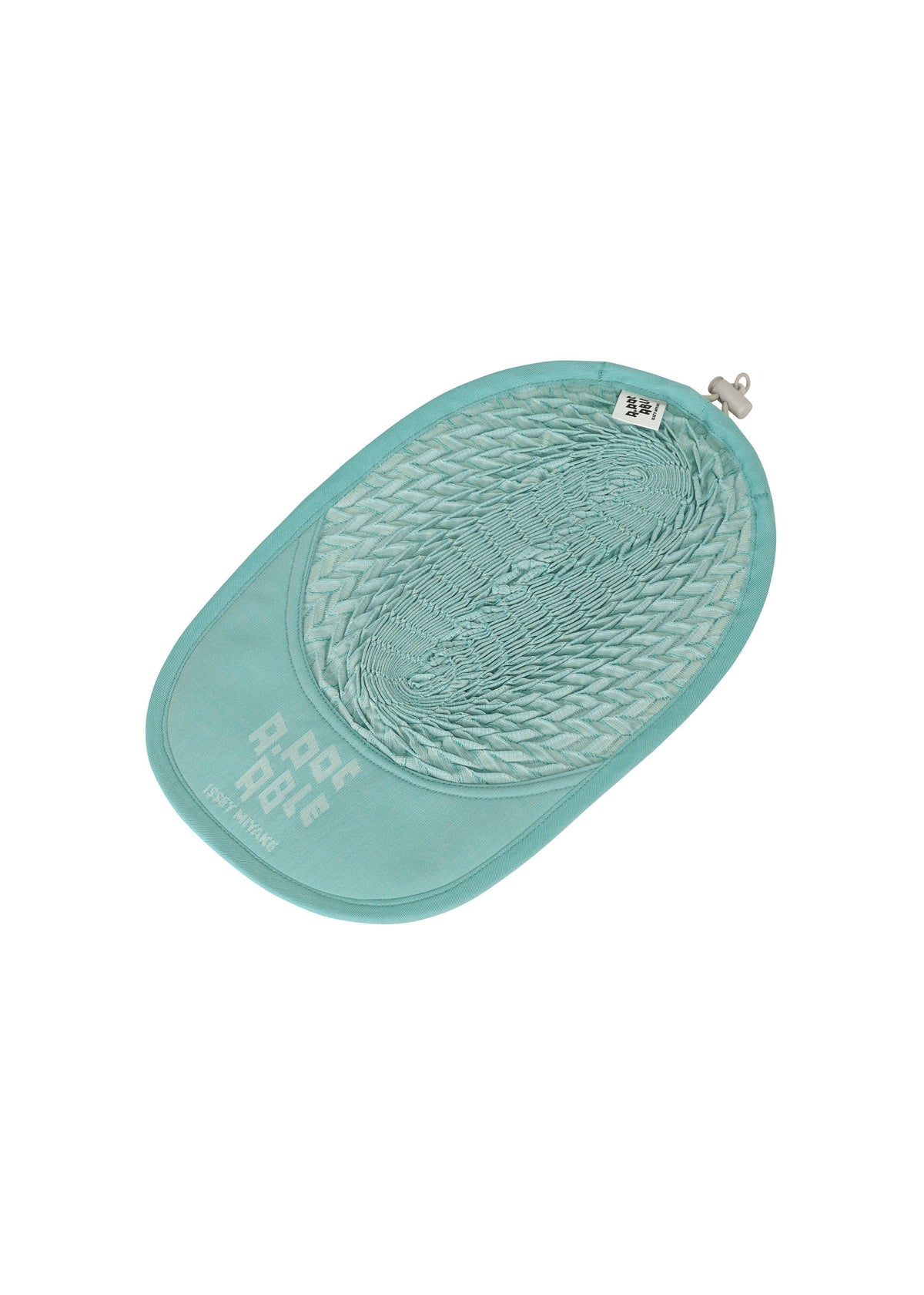 The TYPE-O CAP by A-POC ABLE ISSEY MIYAKE is a light blue, oval pet litter mat featuring a honeycomb texture, a small hanging loop, and "P-PET P-PEE" printed in white on the bottom left corner. view 10 of 15