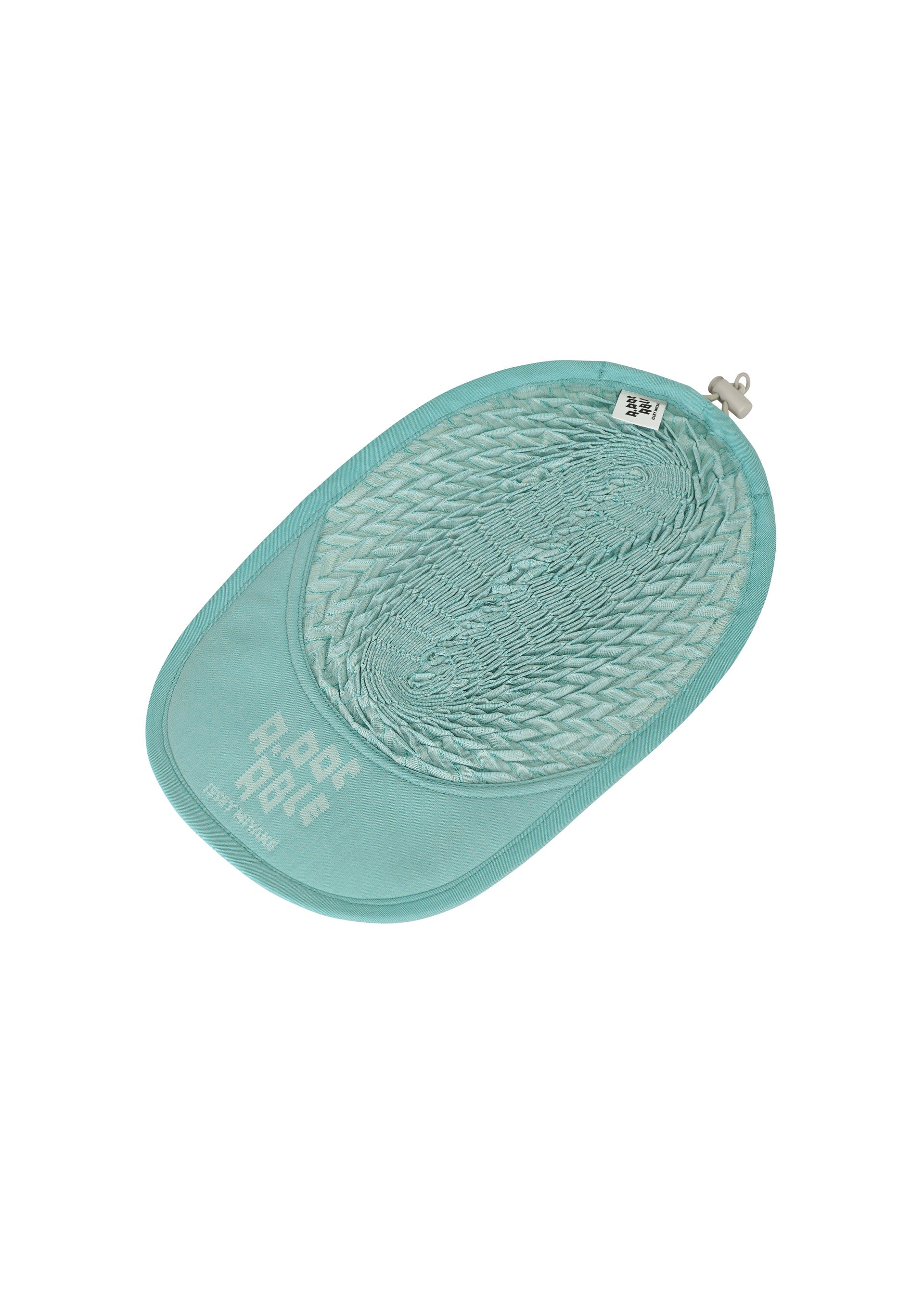 Zoomed view The TYPE-O CAP by A-POC ABLE ISSEY MIYAKE is a light blue, oval pet litter mat featuring a honeycomb texture, a small hanging loop, and "P-PET P-PEE" printed in white on the bottom left corner.