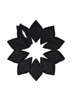 The TYPE-O STOLE 002 by A-POC ABLE ISSEY MIYAKE is a black pleated fabric accessory, crafted with origami folds in a symmetrical star or flower-like pattern, featuring pointed edges and an open center. - BLACK （no.15）
