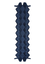 The TYPE-O STOLE 002 by A-POC ABLE ISSEY MIYAKE is a dark blue inflatable sleeping pad with a geometric, origami-inspired wavy pattern, textured surface, angled edges, and integrated lengthwise air chambers.