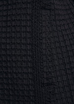 Close-up of TYPE-O 014 by A-POC ABLE ISSEY MIYAKE—black fabric with textured, grid-shaped pleats and a vertical woven seam, ideal for detailed accents on a tailored collar jacket.