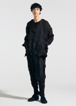 A person stands against a plain background wearing TYPE-P 003-1 by A-POC ABLE ISSEY MIYAKE—a textured black outfit with Baked Stretch pleating, buttoned jacket, soft texture pants, and black shoes—offering versatile everyday wear.