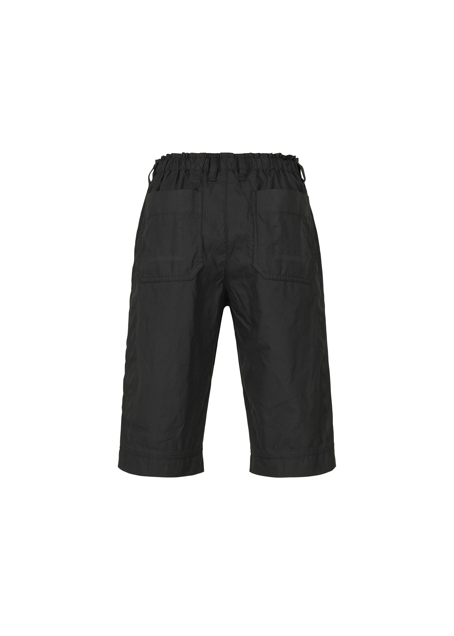 Zoomed view TYPE-U 001 by A-POC ABLE ISSEY MIYAKE: black, knee-length shorts featuring a wrinkle-resistant fabric, elastic waistband, two rear patch pockets, and a relaxed fit, shown against a plain white background.