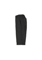 The TYPE-U 001 black cargo shorts by A-POC ABLE ISSEY MIYAKE are shown in a side view, highlighting their large pockets and elastic waistband. These wrinkle-resistant shorts are presented against a plain white background.