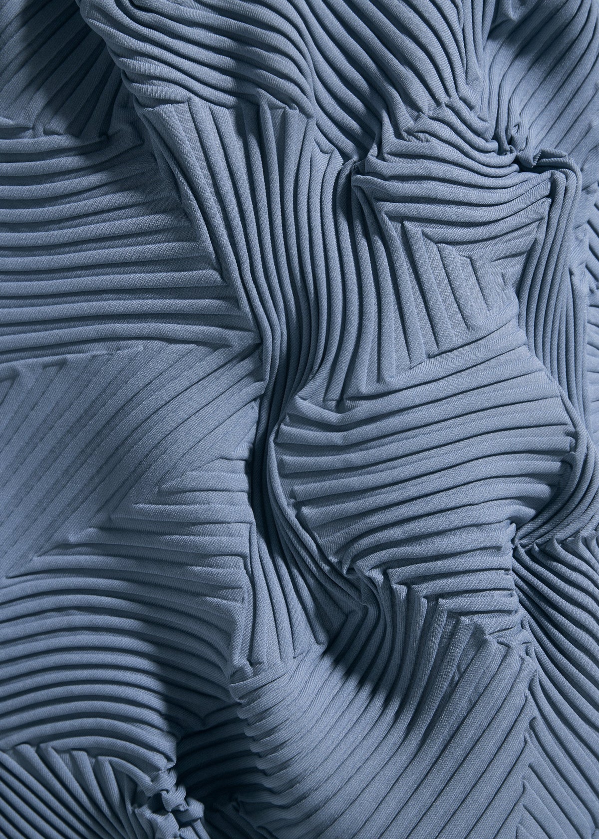 Close-up of TYPE-P 003-2 by A-POC ABLE ISSEY MIYAKE, blue pleated fabric with a geometric pattern, sharp ridges and folds, featuring Baked Stretch for versatile wear and a textured 3D look. view 8 of 8