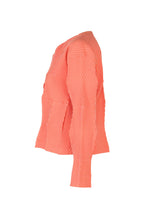 Side view of the TYPE-W 009-1 by A-POC ABLE ISSEY MIYAKE: a relaxed fit, long-sleeve shirt with orange and white geometric stripes forming squares, crafted from lightweight, stretchy polyester.