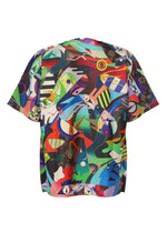 The TYPE-XII Tomokazu Matsuyama project 004 from A-POC ABLE ISSEY MIYAKE is a short-sleeve shirt showcasing a bold, colorful abstract pattern with various shapes, lines, and vibrant hues on the back, inspired by the brand’s collaboration with contemporary artist Tomokazu Matsuyama.