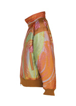 Side view of the 001 TYPE-XVI Etsu Egami project jacket by A-POC ABLE ISSEY MIYAKE, featuring a high neck, vibrant multi-colored swirl pattern, a zippered pocket, and brown ribbed cuffs and hem.