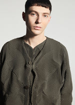 A person with short dark hair wears the TYPE-O 010-1 jacket by A-POC ABLE ISSEY MIYAKE, featuring textured olive-green fabric and large buttons, standing against a plain light grey background.