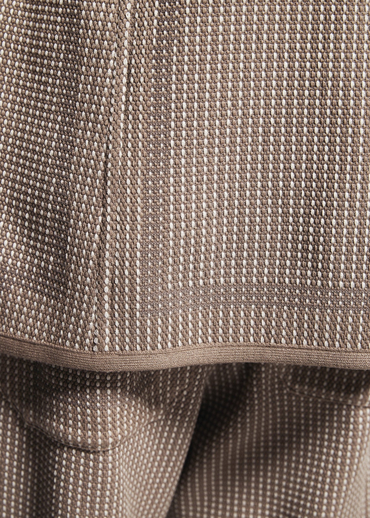 Close-up of TYPE-K 012 by A-POC ABLE ISSEY MIYAKE, featuring textured brown fabric with a white dotted pattern and visible seams in a sashiko-inspired layered design. view 8 of 8