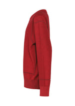The TYPE-K 010 by A-POC ABLE ISSEY MIYAKE is a red long-sleeved knit top shown from the side on a white background, featuring ribbed cuffs, hem, and a crew neckline for a classic style.