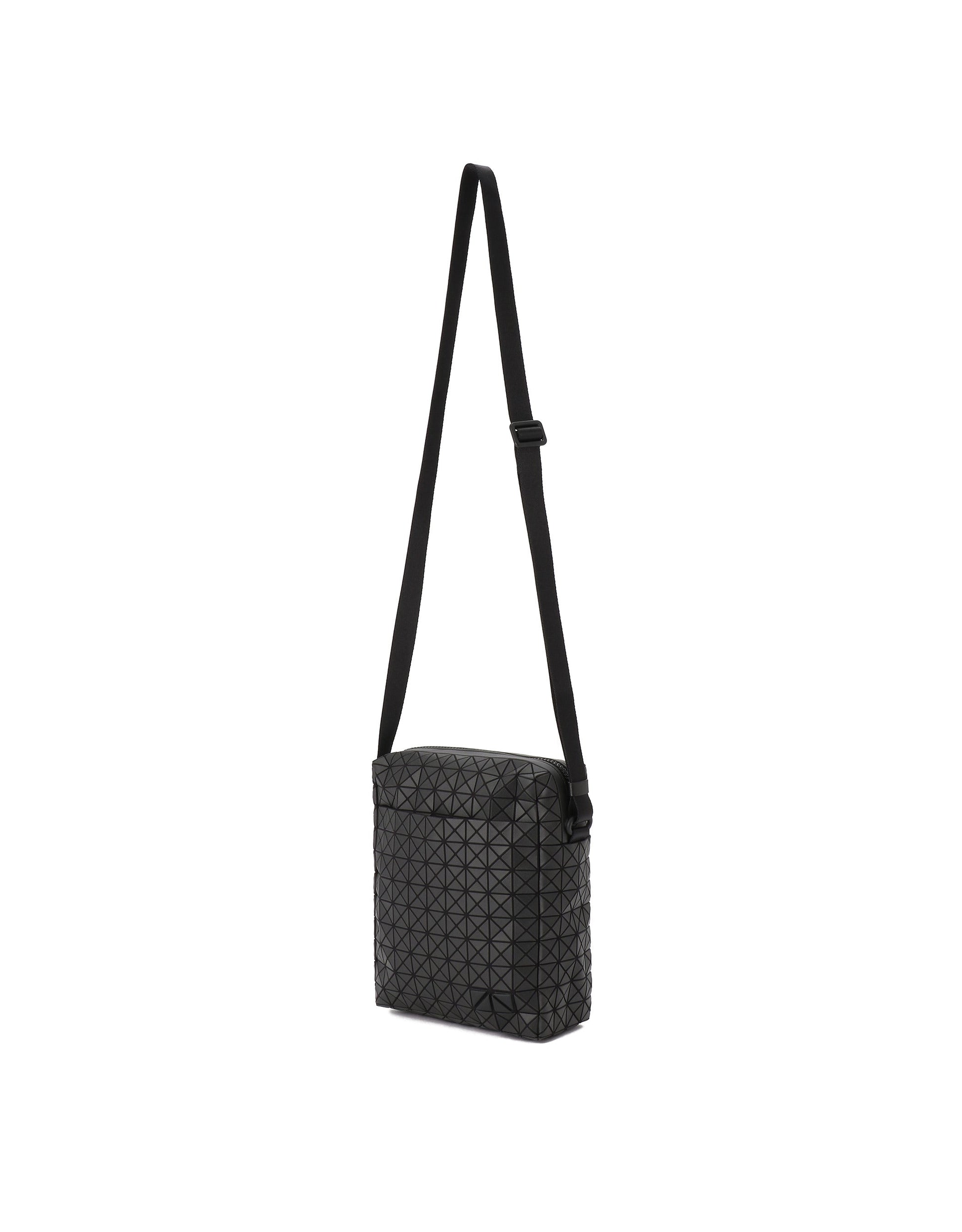 Zoomed view The VOYAGER by BAO BAO ISSEY MIYAKE is a small black vertical shoulder bag with an adjustable strap and a distinctive geometric triangular pattern on its exterior. Designed for convenience, it includes water bottle storage and is shown against a plain white background.