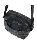 The VOYAGER by BAO BAO ISSEY MIYAKE is a compact black vertical shoulder bag featuring a signature geometric pattern. Shown open, it reveals a spacious, lined interior and an inner fabric strap for organization—making it the ideal travel companion with plenty of space for your essentials.