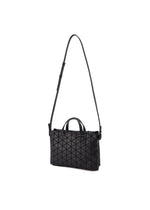 The TONNEAU MATTE by BAO BAO ISSEY MIYAKE is a black, barrel-shaped shoulder bag with a leather-like geometric pattern, adjustable long strap, and two short handles, shown against a plain white background.