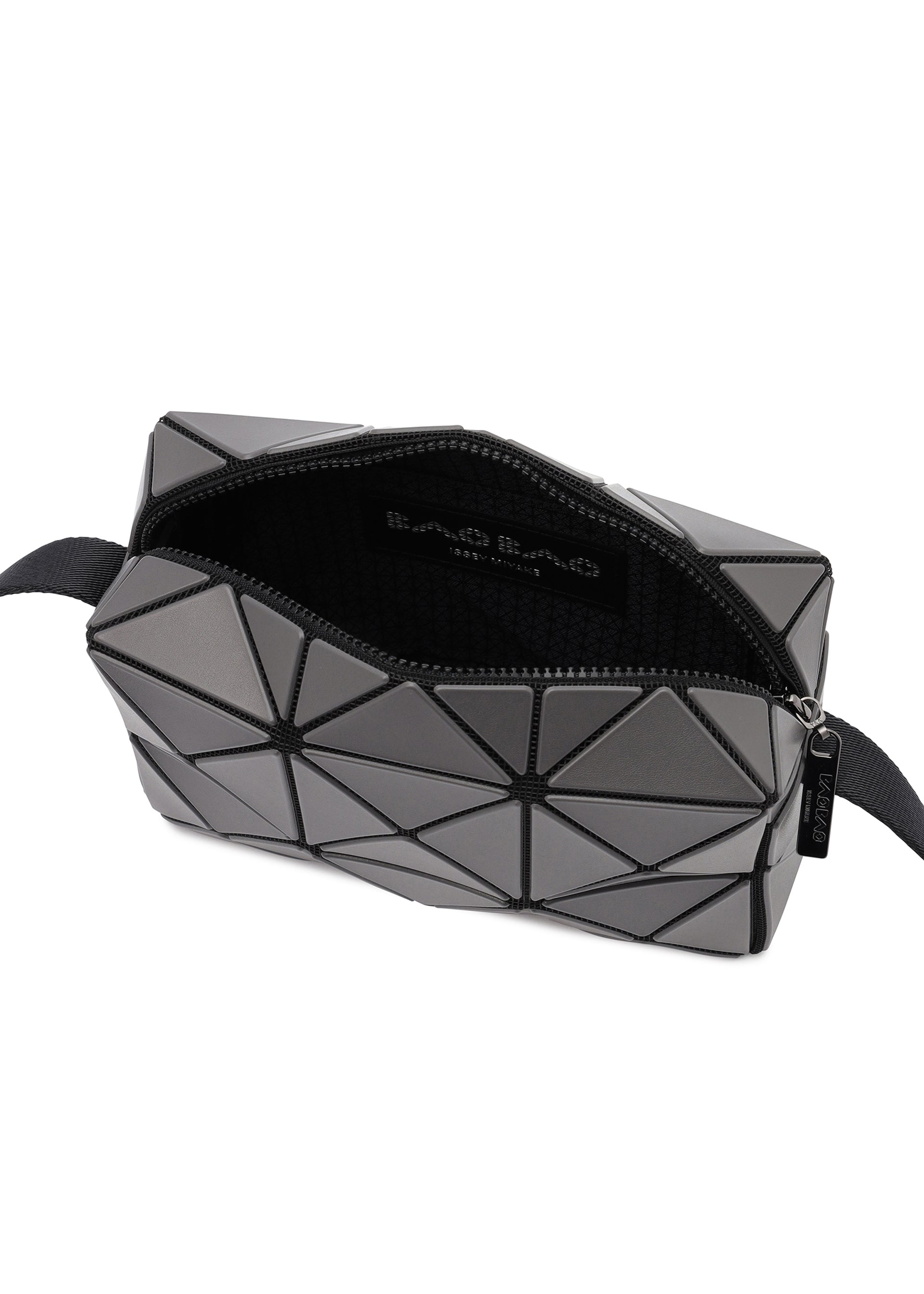 Zoomed view The CUBOID clutch bag by BAO BAO ISSEY MIYAKE features geometric gray triangular panels, a minimalist design, a black zipper partially open to reveal a black interior with the brand logo, and an adjustable strap attached to one side.
