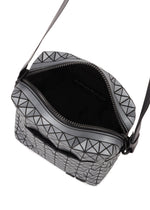 The VOYAGER REFLECTOR by BAO BAO ISSEY MIYAKE is a small, black and silver geometric crossbody with an open zipper showing its sleek black interior and visible logo, reflecting the modern metallic style of the brand's tote bags.