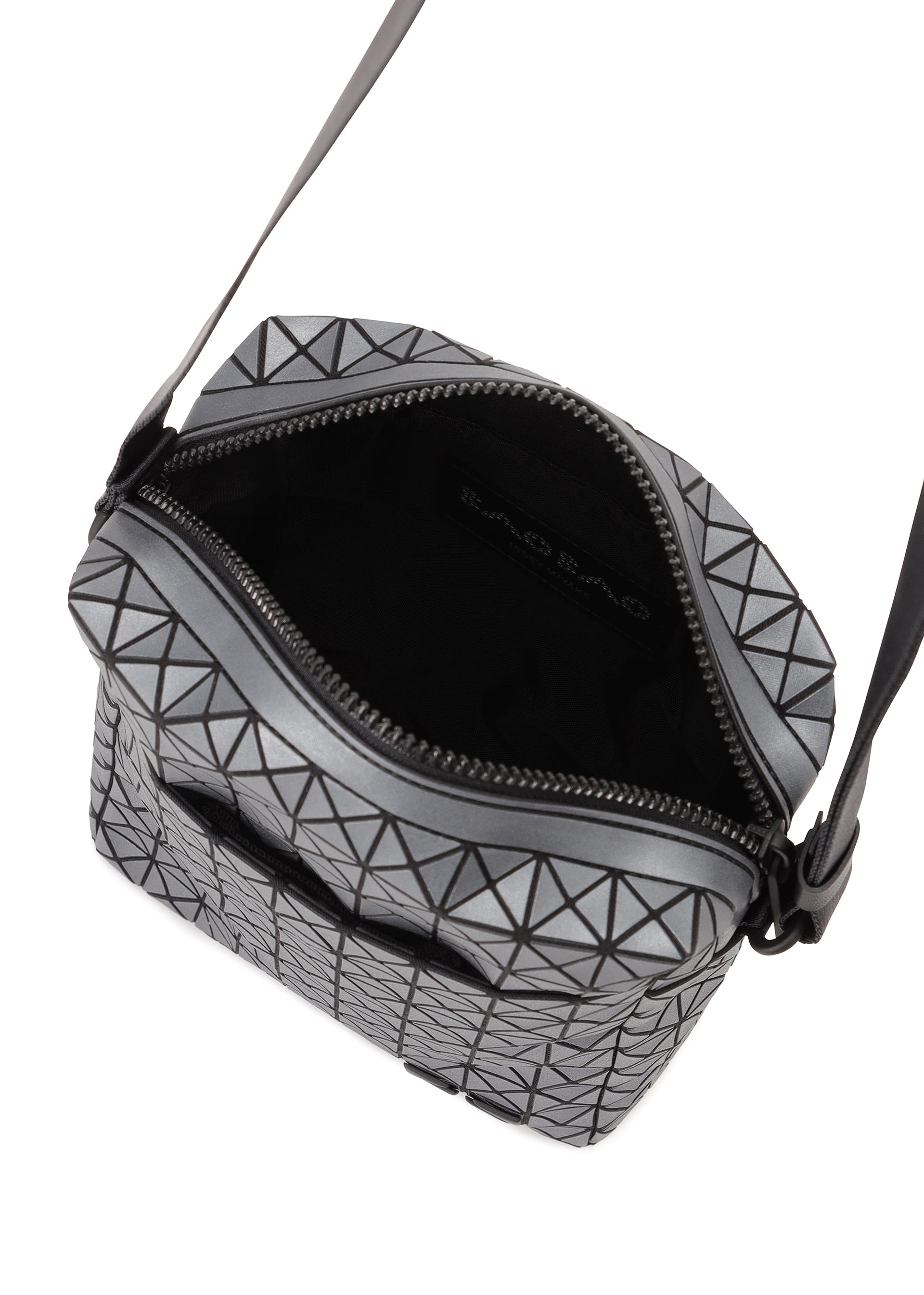 Zoomed view The VOYAGER REFLECTOR by BAO BAO ISSEY MIYAKE is a small, black and silver geometric crossbody with an open zipper showing its sleek black interior and visible logo, reflecting the modern metallic style of the brand's tote bags.