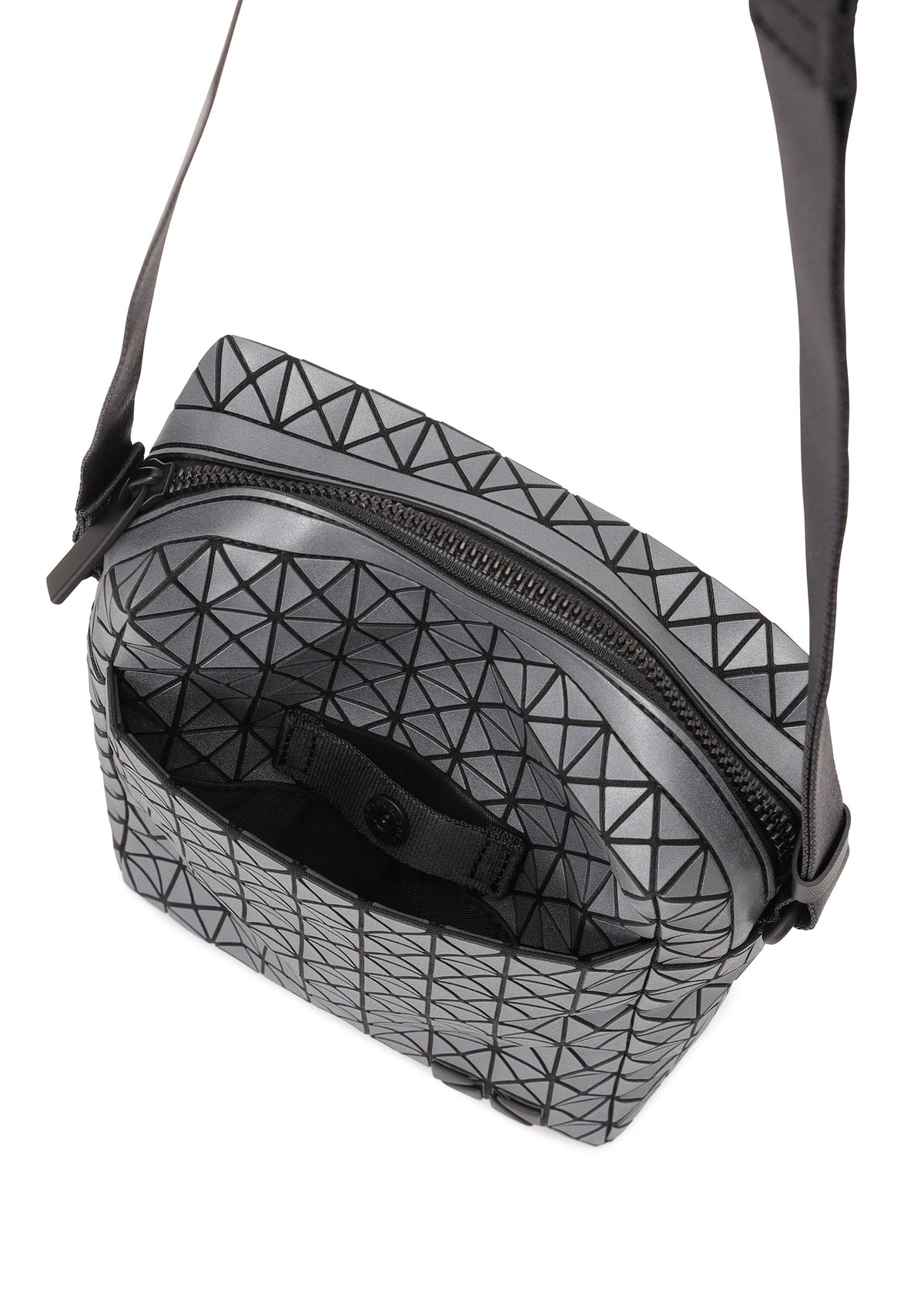 The VOYAGER REFLECTOR by BAO BAO ISSEY MIYAKE is a crossbody bag featuring black triangular lines on a gray, reflective surface, with a black zipper, adjustable strap, and an open top showing the inner compartment. view 4 of 7
