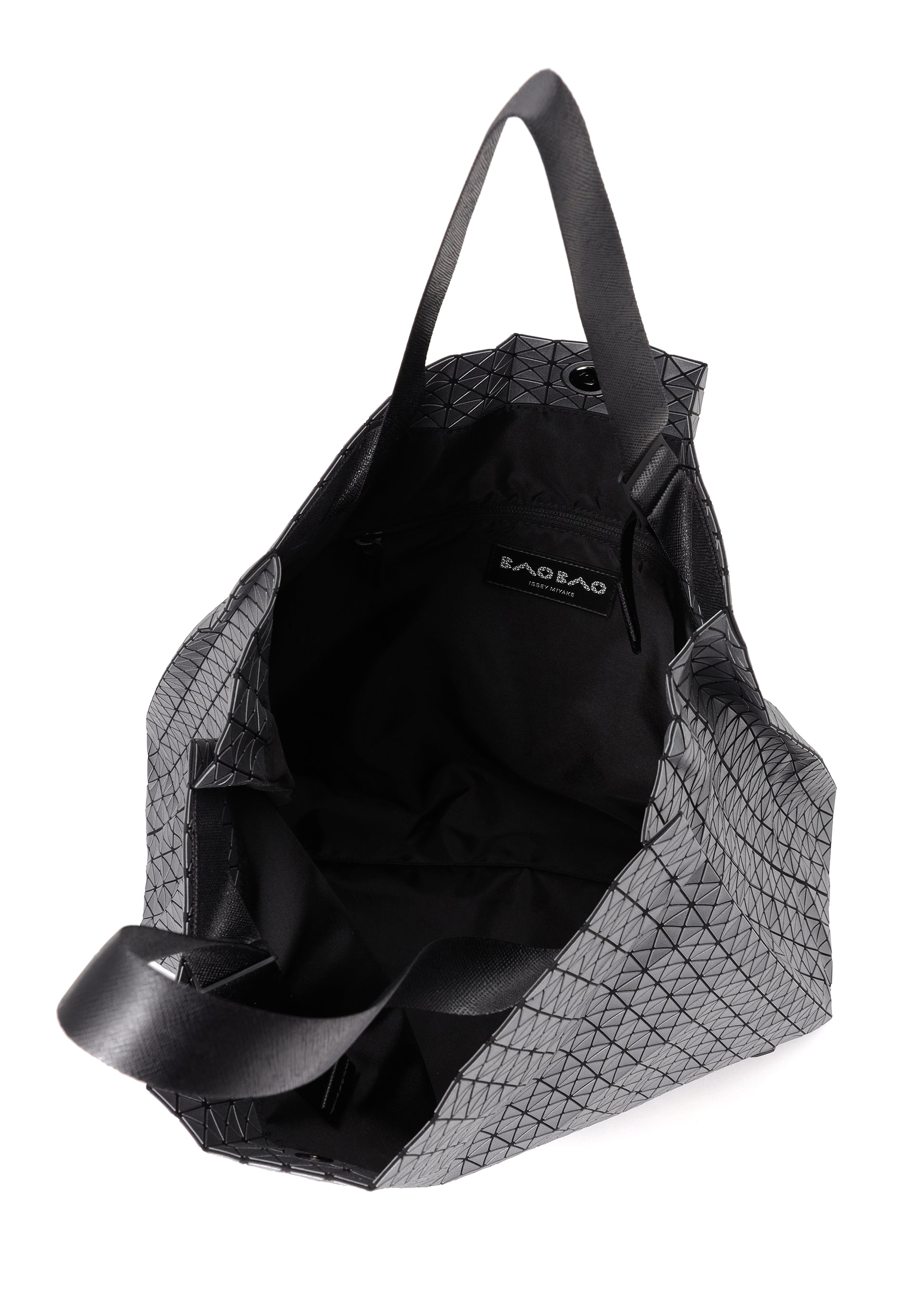 Zoomed view The CART REFLECTOR tote by BAO BAO ISSEY MIYAKE features a geometric gray metallic design, black adjustable handles, and an open view highlighting its spacious black interior with a visible label inside.