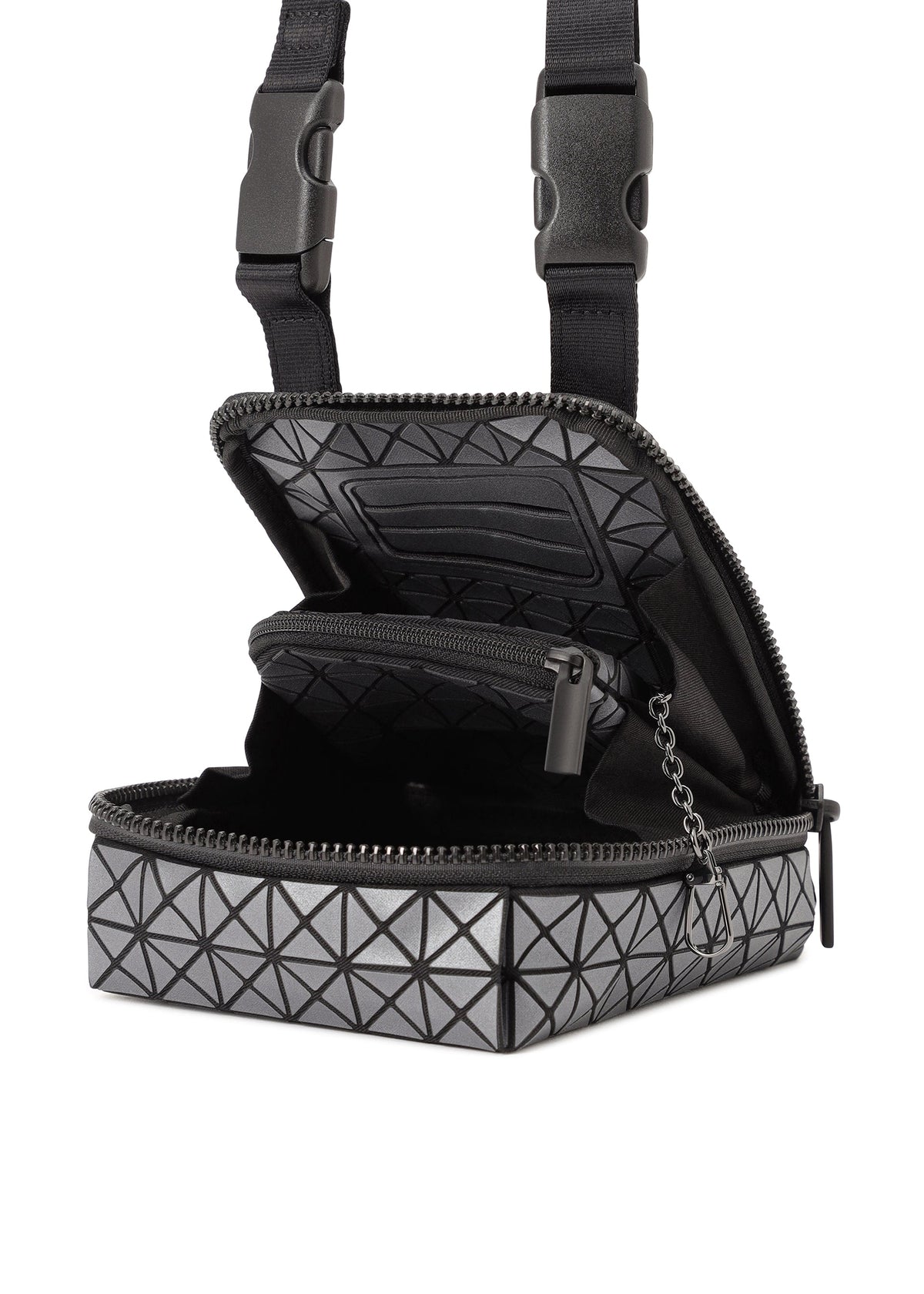 The BEETLE REFLECTOR by BAO BAO ISSEY MIYAKE is a small, boxy gray bag with a geometric triangle pattern and reflective finish, featuring black zipper with chain pull, adjustable black straps, and an open main compartment showing an inner zip pocket. view 4 of 8