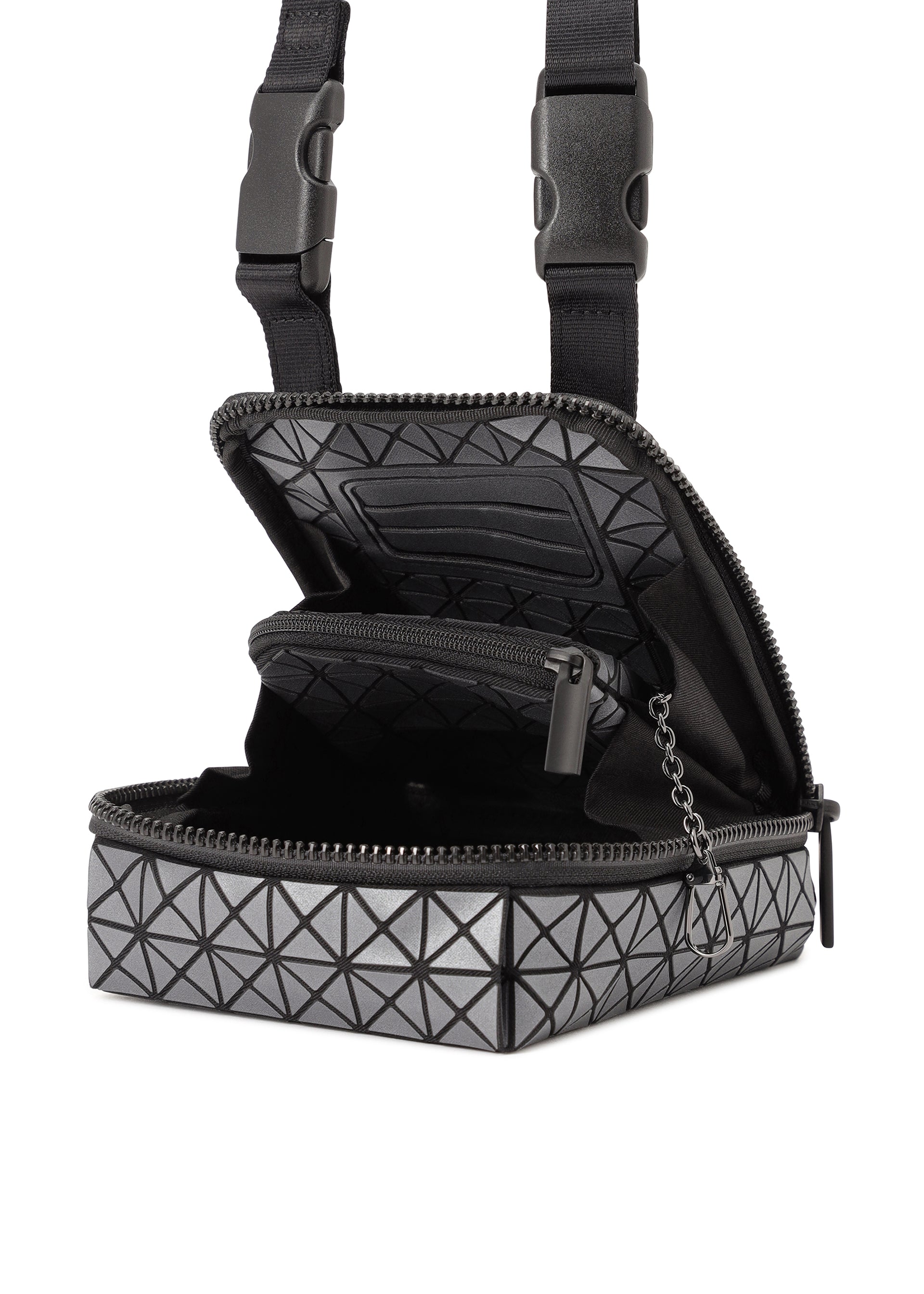 Zoomed view The BEETLE REFLECTOR by BAO BAO ISSEY MIYAKE is a small, boxy gray bag with a geometric triangle pattern and reflective finish, featuring black zipper with chain pull, adjustable black straps, and an open main compartment showing an inner zip pocket.