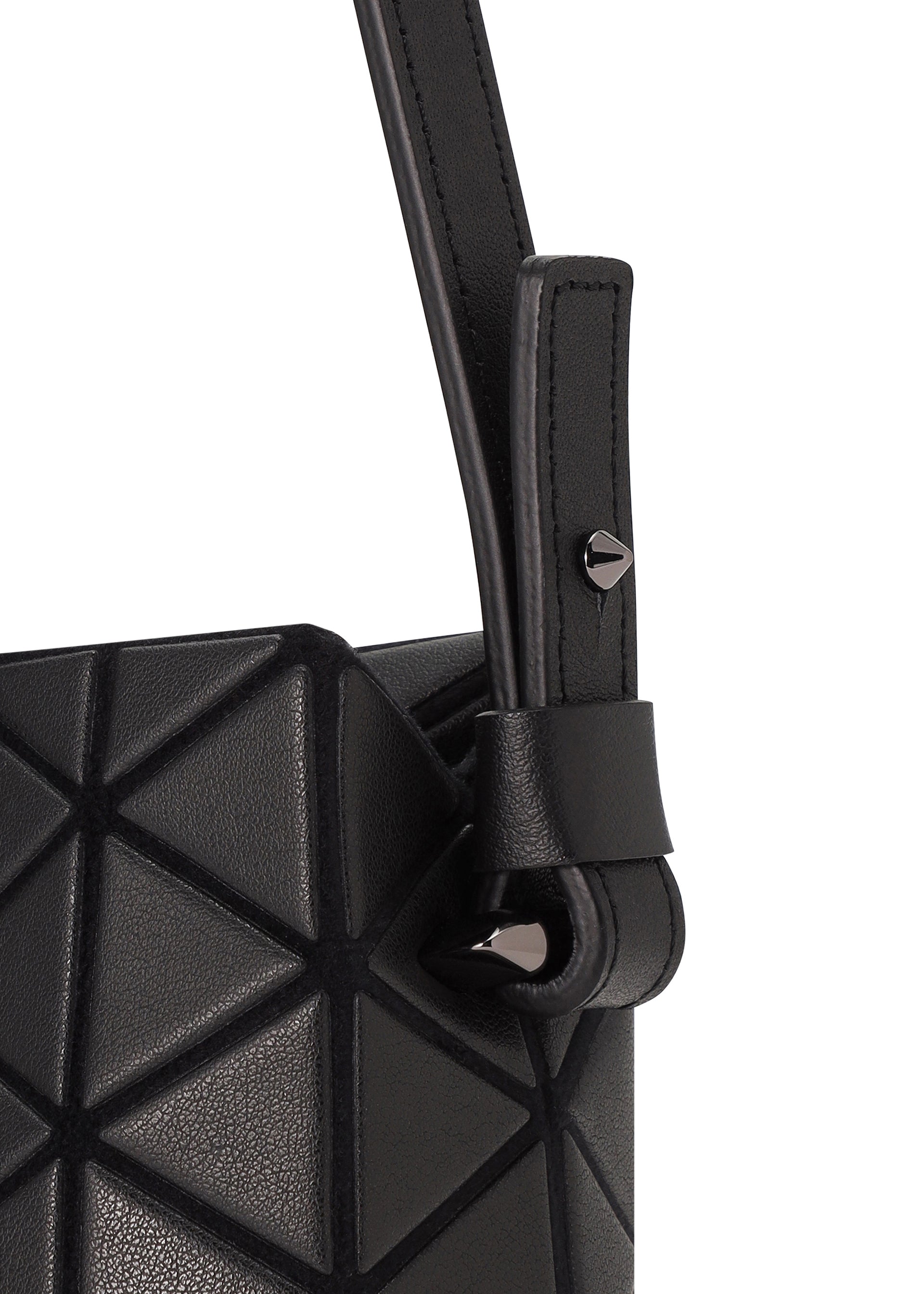Zoomed view Close-up of the TONNEAU MATTE mini handbag by BAO BAO ISSEY MIYAKE, featuring black leather-like material, geometric triangular patterns, and a strap looped through a metal stud.