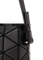 Close-up of the TONNEAU MATTE handbag by BAO BAO ISSEY MIYAKE, featuring a black, leather-like finish with geometric triangular patterns and a strap secured by a metal stud for a sophisticated, stylish look.