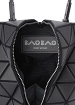 Close-up of the BAO BAO ISSEY MIYAKE TORSO handbag: a black equilateral triangle shape with a geometric pattern, open zipper, and visible inner label.
