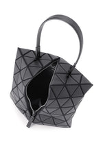 The TORSO handbag by BAO BAO ISSEY MIYAKE features a geometric black equilateral triangle design with raised shapes, a single handle, and a partially open zipper that reveals the interior for a modern, stylish look.