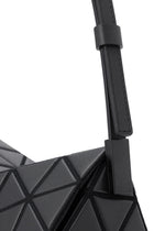 Close-up of the TORSO shoulder bag by BAO BAO ISSEY MIYAKE, showcasing its black geometric triangular pattern and smooth, adjustable leather-like strap.