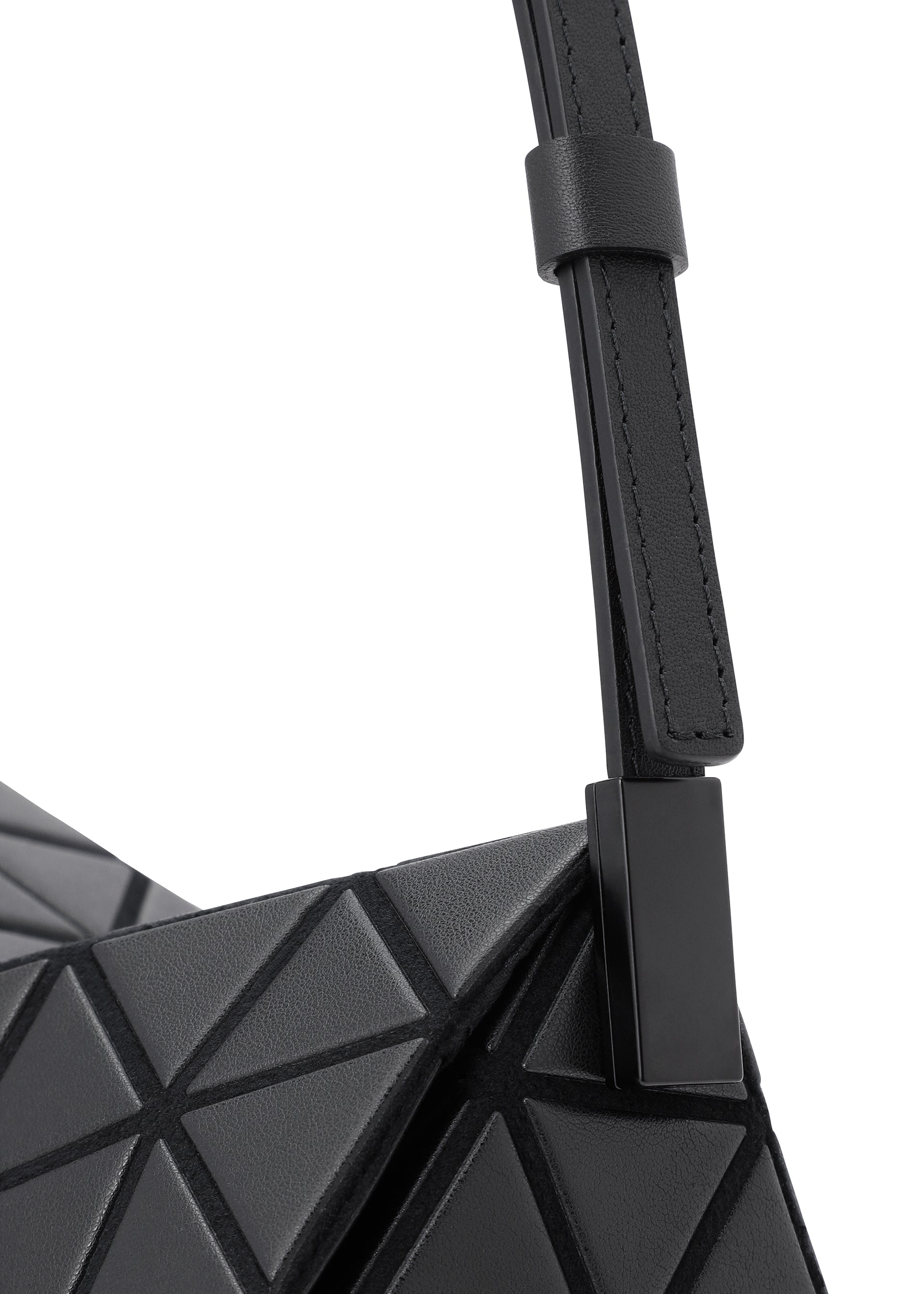 Zoomed view Close-up of the TORSO shoulder bag by BAO BAO ISSEY MIYAKE, showcasing its black geometric triangular pattern and smooth, adjustable leather-like strap.