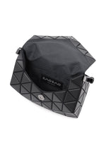 The black BAO BAO ISSEY MIYAKE TORSO shoulder bag features a geometric, leather-like exterior, stylish curved shape, magnetic snap closure, and opens to reveal a fabric-lined interior with the Bao Bao label visible.