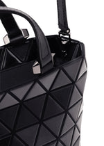Close-up of the CRYSTAL GLOSS mini handbag by BAO BAO ISSEY MIYAKE in black cowhide leather, showcasing a geometric triangular pattern with silver square studs near the handle, set against a white background.