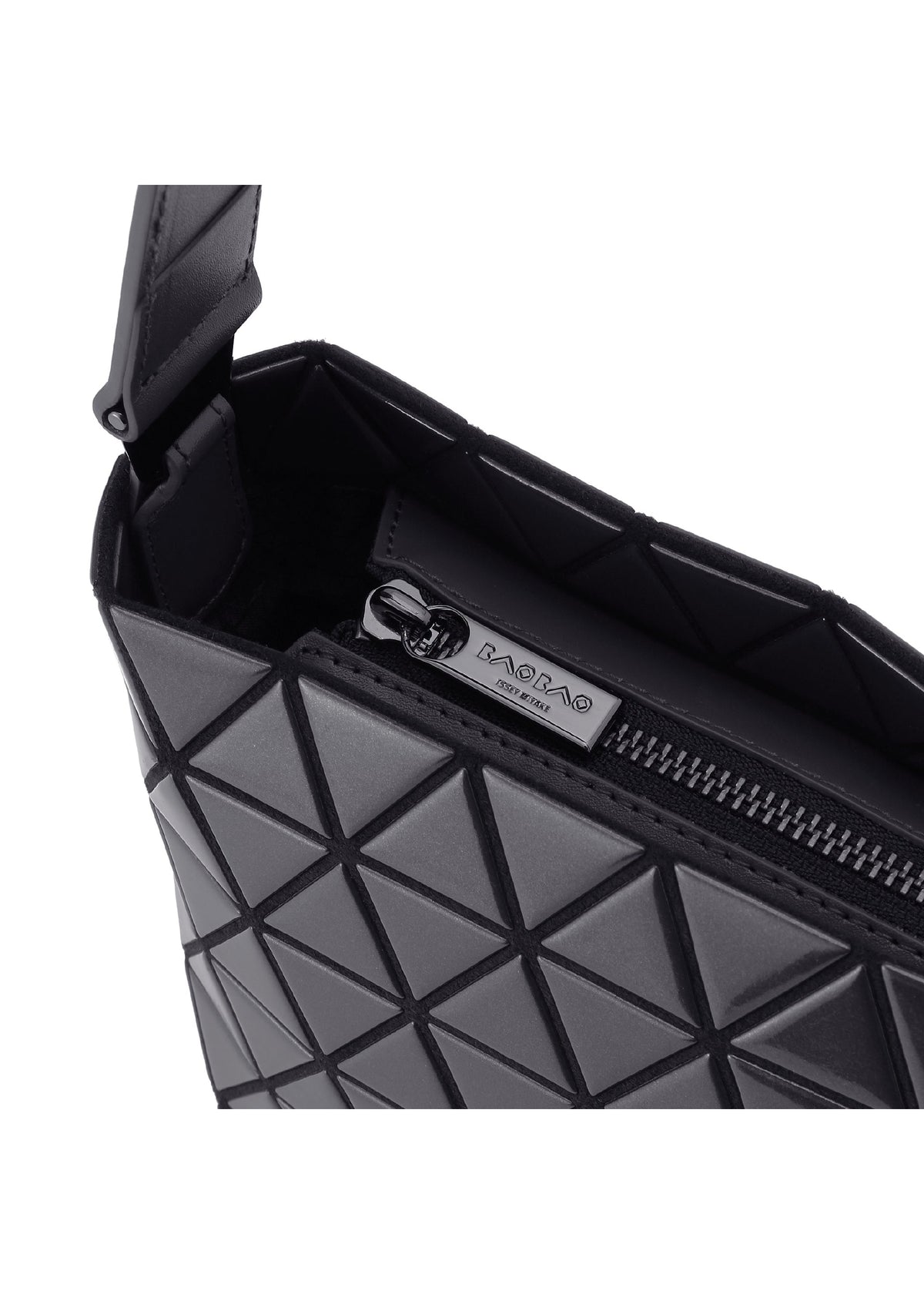 Close-up of the CRYSTAL GLOSS shoulder bag by BAO BAO ISSEY MIYAKE, featuring a black geometric pattern, a partially open zipper, and a silver metal logo tag inside the glossy enamel interior. view 4 of 6