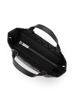 Top view of an open BAO BAO ISSEY MIYAKE CRYSTAL MATTE black quilted mini handbag with leather straps, double handles, zippered interior pocket, and a visible metal brand tag on the lining.