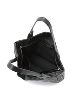 The ROCK MATTE by BAO BAO ISSEY MIYAKE is a black geometric handbag with two handles, a gusseted bottom, zippered inner pocket, and modern triangular design. It fits essentials and up to a 13-inch laptop.