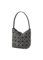 The VALLEY handbag by BAO BAO ISSEY MIYAKE features a modern black geometric design with a single strap and a triangular tessellated exterior, displayed upright on a plain white background.