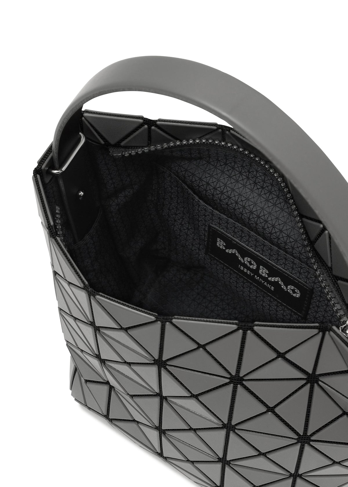 Close-up of the BAO BAO ISSEY MIYAKE VALLEY handbag: upright, featuring a modern geometric gray design with black triangular panels, a partially open zipper revealing patterned lining and a branded label inside. view 7 of 8