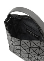 Close-up of the BAO BAO ISSEY MIYAKE VALLEY handbag: upright, featuring a modern geometric gray design with black triangular panels, a partially open zipper revealing patterned lining and a branded label inside.