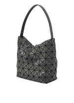 The VALLEY tote bag by BAO BAO ISSEY MIYAKE features a black geometric, triangular-textured design and a single wide strap. This upright-standing handbag is photographed against a white background.