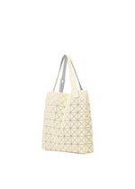 A cream-colored BAO BAO ISSEY MIYAKE PRISM PLUS tote bag featuring a geometric triangular pattern, two light handles, and a textured fabric grain is displayed against a plain white background.