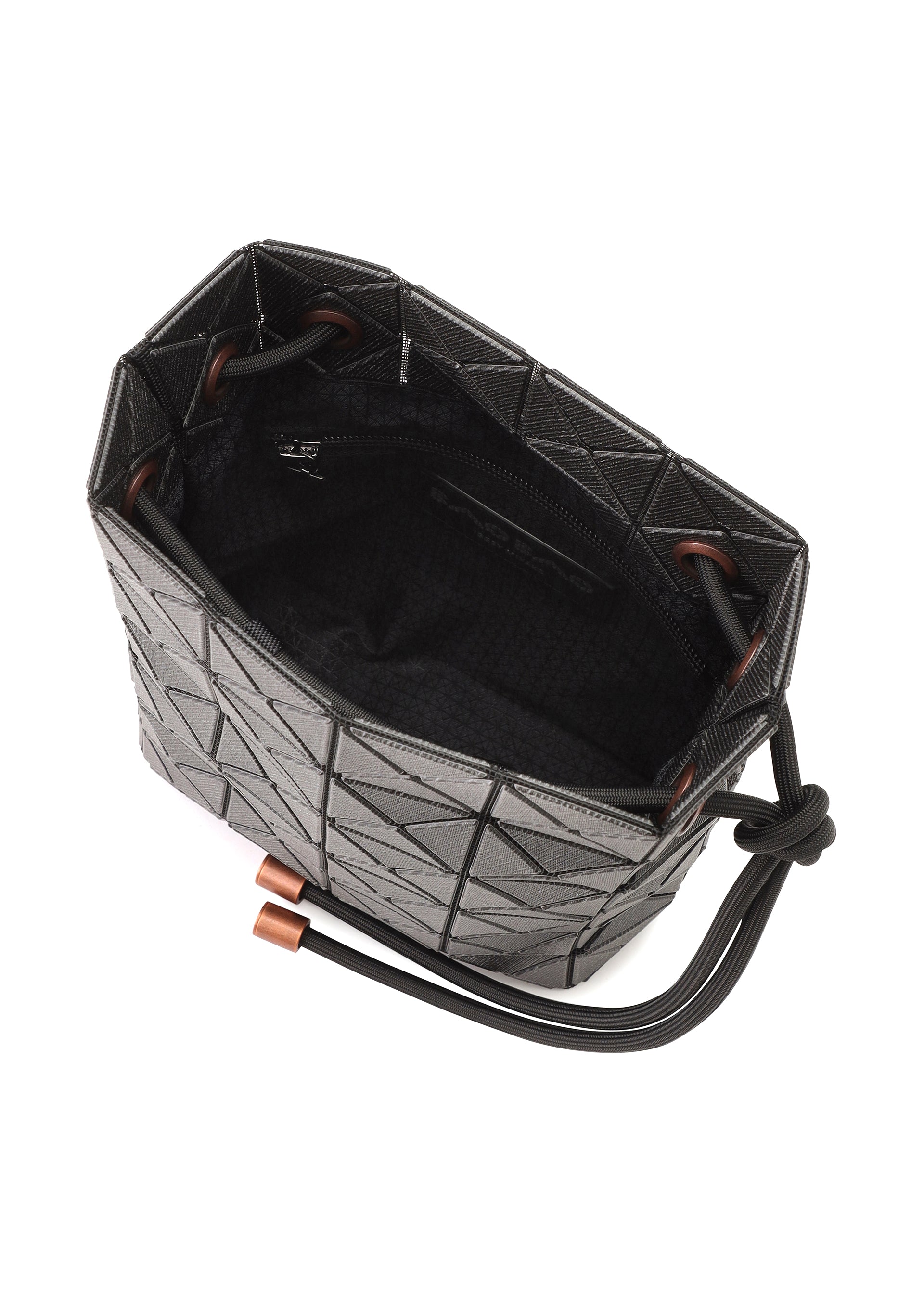 Zoomed view The WRING DENIM by BAO BAO ISSEY MIYAKE is an open black geometric-patterned drawstring bag with a soft, fabric-lined interior, inner zip pocket, and black drawstring closure featuring copper-toned metal tips.