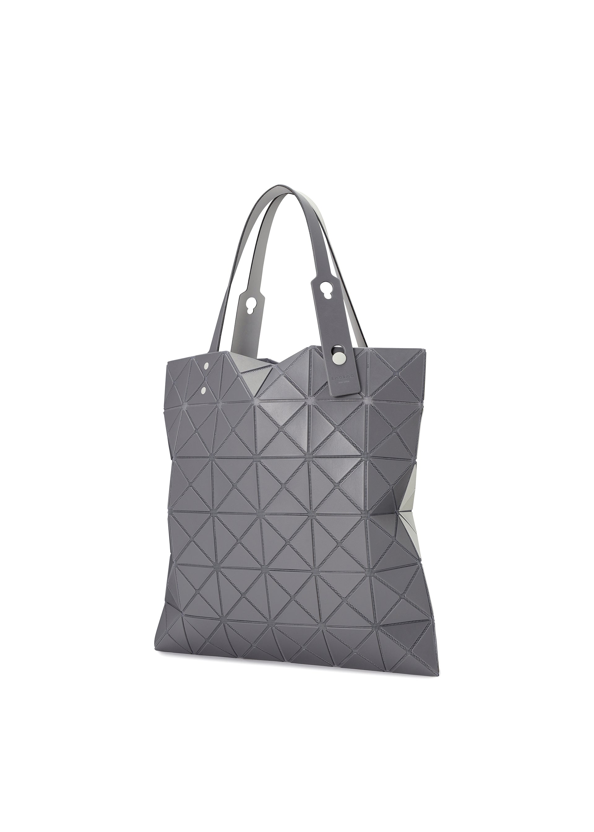 Zoomed view The LUCENT W COLOR by BAO BAO ISSEY MIYAKE is a grey tote bag with geometric patterns, short handles, and a modern leather-like sheen. It fits a 13-inch laptop and is shown on a white background.