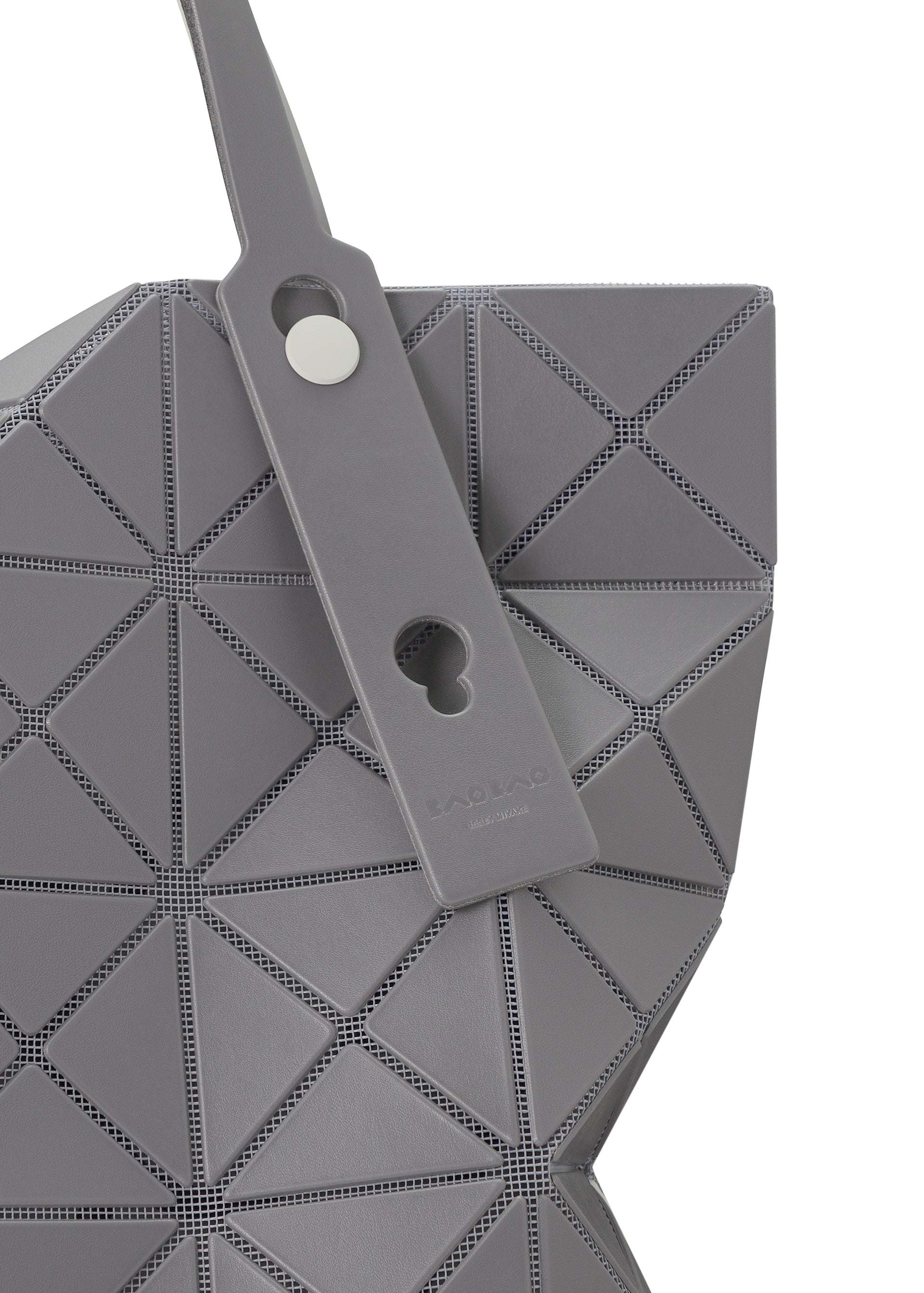 Zoomed view Close-up of the BAO BAO ISSEY MIYAKE LUCENT W COLOR tote, featuring a gray geometric design with triangular panels, leather-like strap, silver button, rectangular tag, and roomy enough to fit a 13-inch laptop.