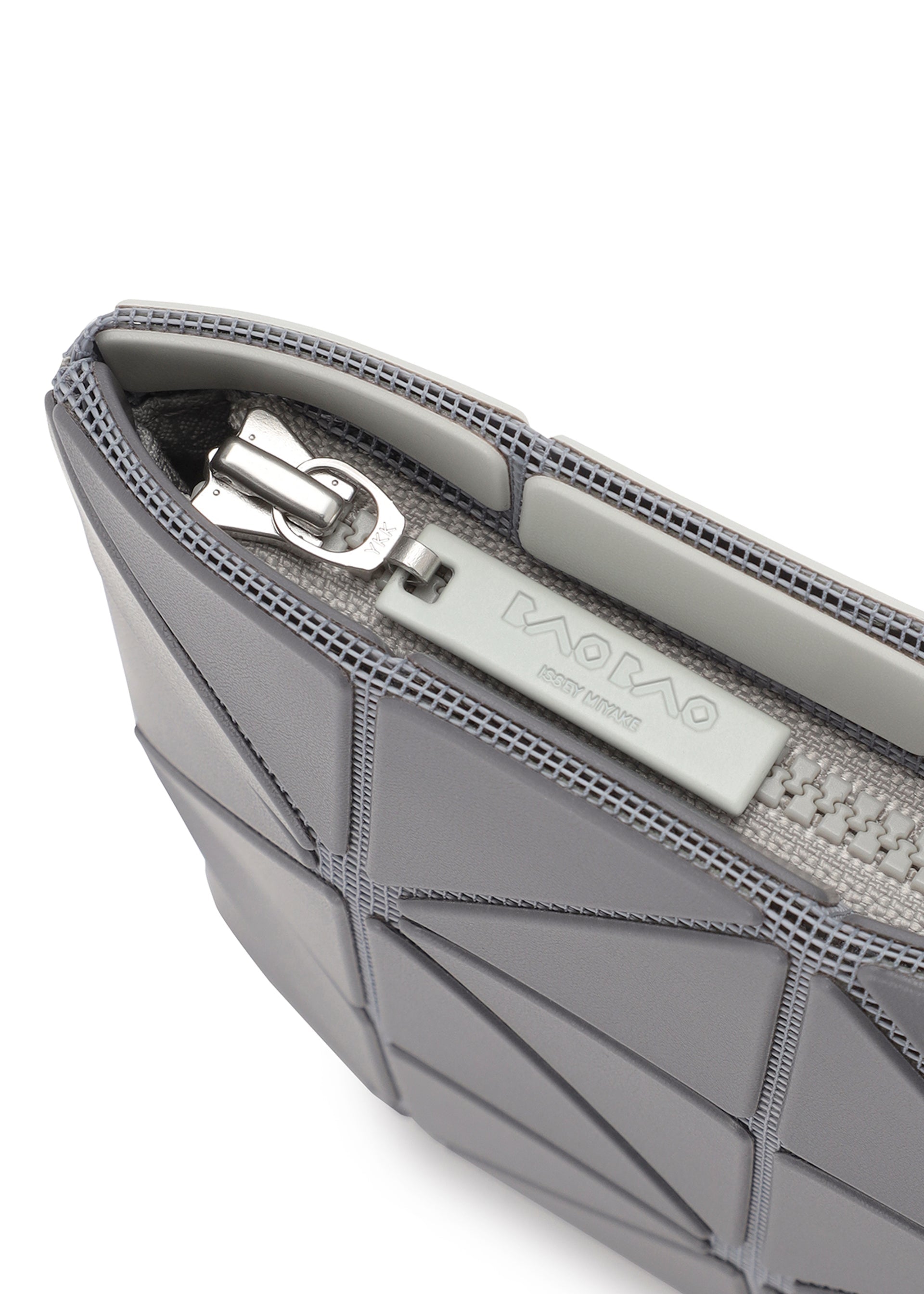 Zoomed view Close-up of the LUCENT W COLOR by BAO BAO ISSEY MIYAKE, a gray matte pouch with geometric patterns, silver zipper, and inner brand tag—perfect as a stylish passport pouch.